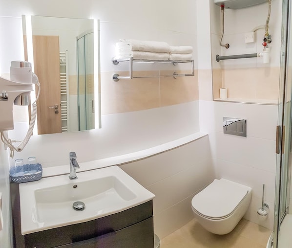 Shower, rainfall showerhead, designer toiletries, hair dryer