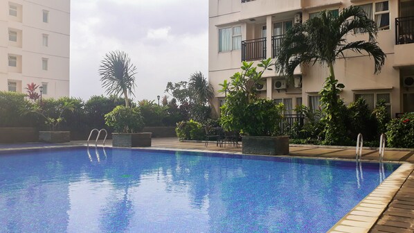 Outdoor pool - Homey Studio Apartment at Margonda Residence 3 (Depok)