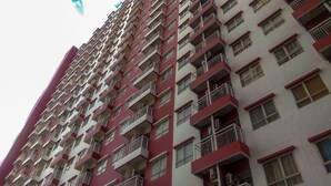 A high-rise residential building with multiple balconies and windows. - Best Price 2BR at Taman Melati Margonda Apartment (Depok)