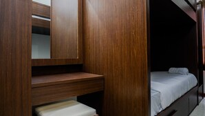 A bedroom with a wooden wardrobe, a bench, and a bed. - Best Price 2BR at Taman Melati Margonda Apartment (Depok)