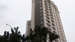 A tall residential building with multiple balconies and windows. - Modern and Comfy Studio @ Mustika Golf Apartment (Cikarang)
