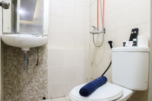 A bathroom with a sink, toilet, and shower.