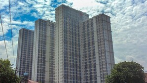A high-rise residential building with multiple floors and balconies.