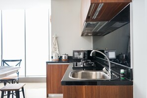 Fridge, stovetop, electric kettle, cookware/dishes/utensils - South Tower 2BR at L'Avenue Apartment (Jakarta)