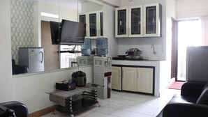 A compact living space with a kitchenette, a dining area, and a seating area. - Minimalist 2BR Apartment at Gateway Ahmad Yani (Bandung)