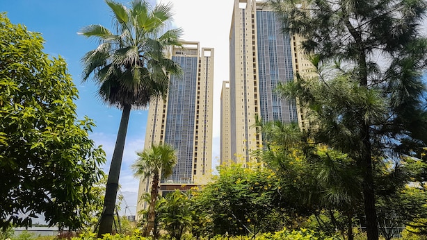 Two high-rise buildings with a clear sky and surrounding greenery. - Elegant 1BR Branz BSD Apartment near AEON Mall (Pagedangan)