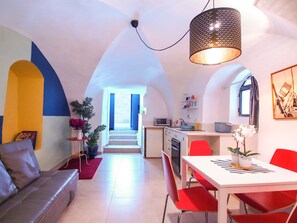A modern interior with a dining area, kitchen, and living space.