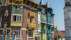Une rangée de bâtiments historiques aux couleurs vives, caractérisés par des styles architecturaux distincts et dotés de balcons.