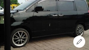 A black van parked on a paved surface. - BCBG KinShasa Apartment (Limete)