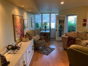 Relax in a spacious living area with a comfortable seating arrangement, dining table, and large window.