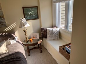 Relax in a cozy seating area with a comfortable bench and a view of the outside.