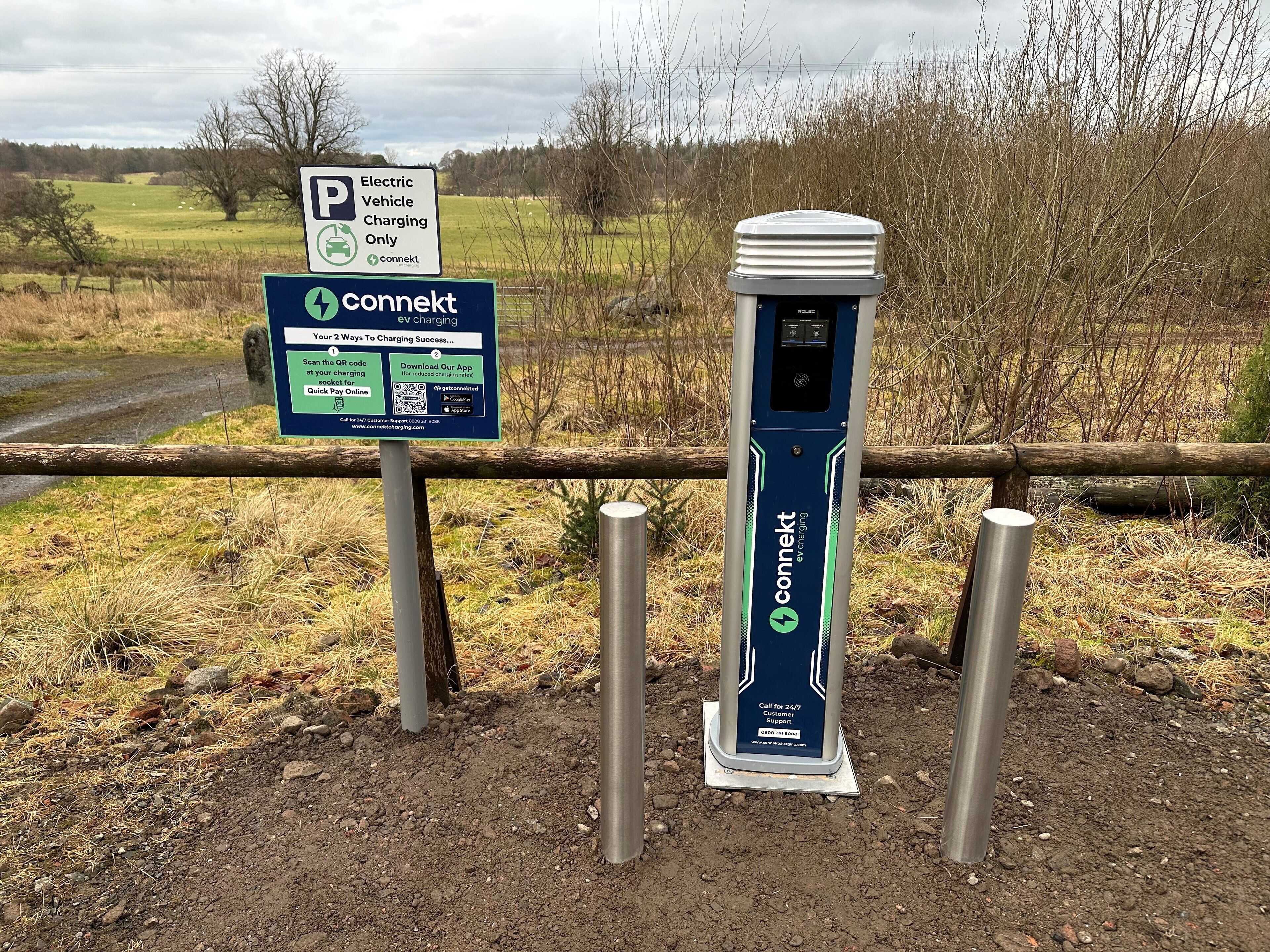 An electric vehicle charging station with a sign indicating it is for electric vehicles only.