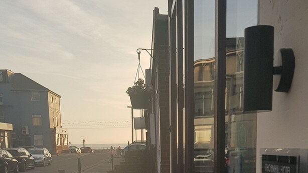 A hotel exterior with wooden benches, a view of the street, and a sign indicating room number 14. - Thornhill Blackpool (Blackpool)