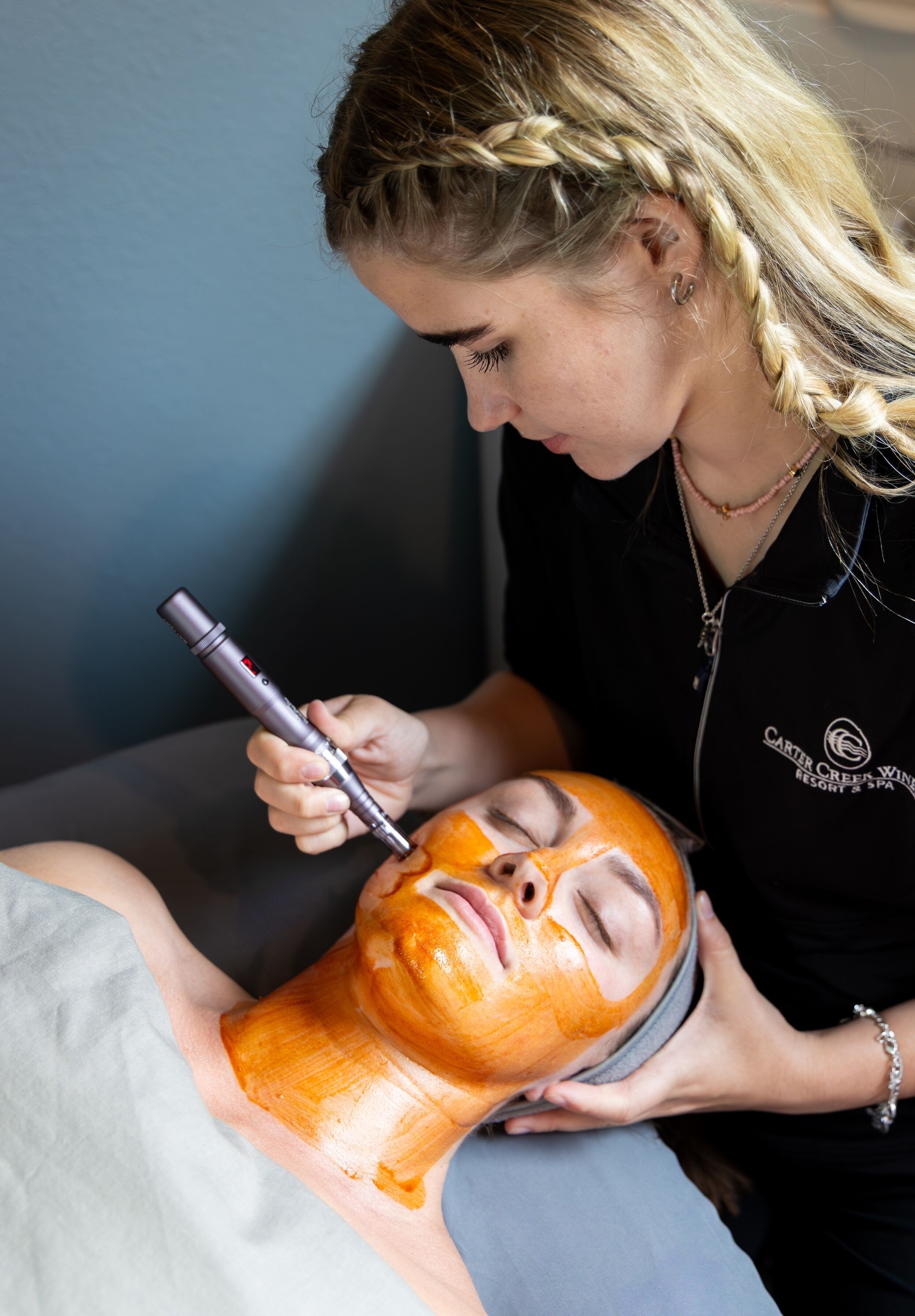 Una persona recibiendo un tratamiento facial con un aparato en la cara.