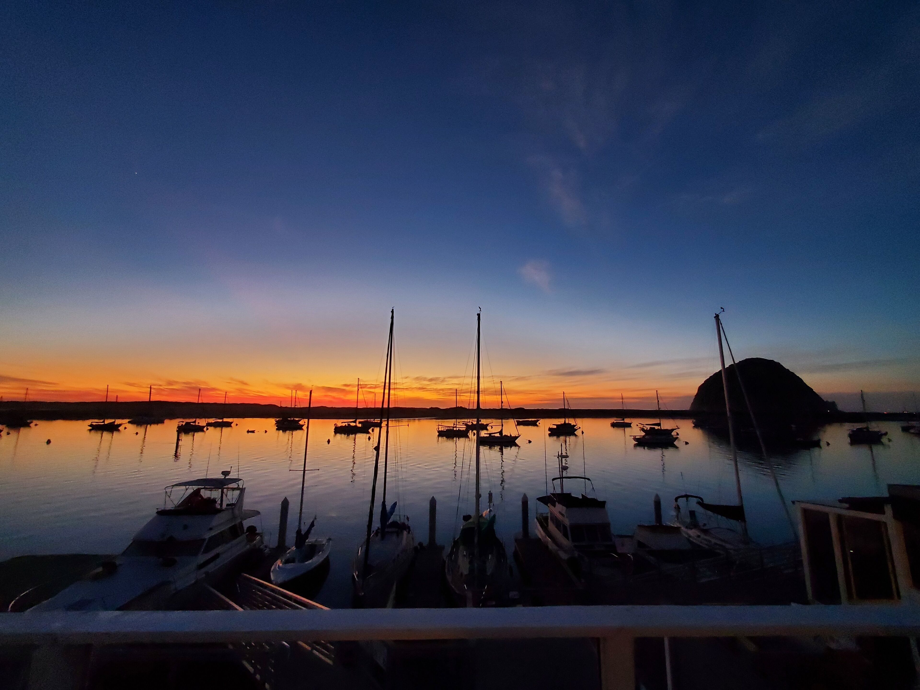 A marina at dusk with boats docked.