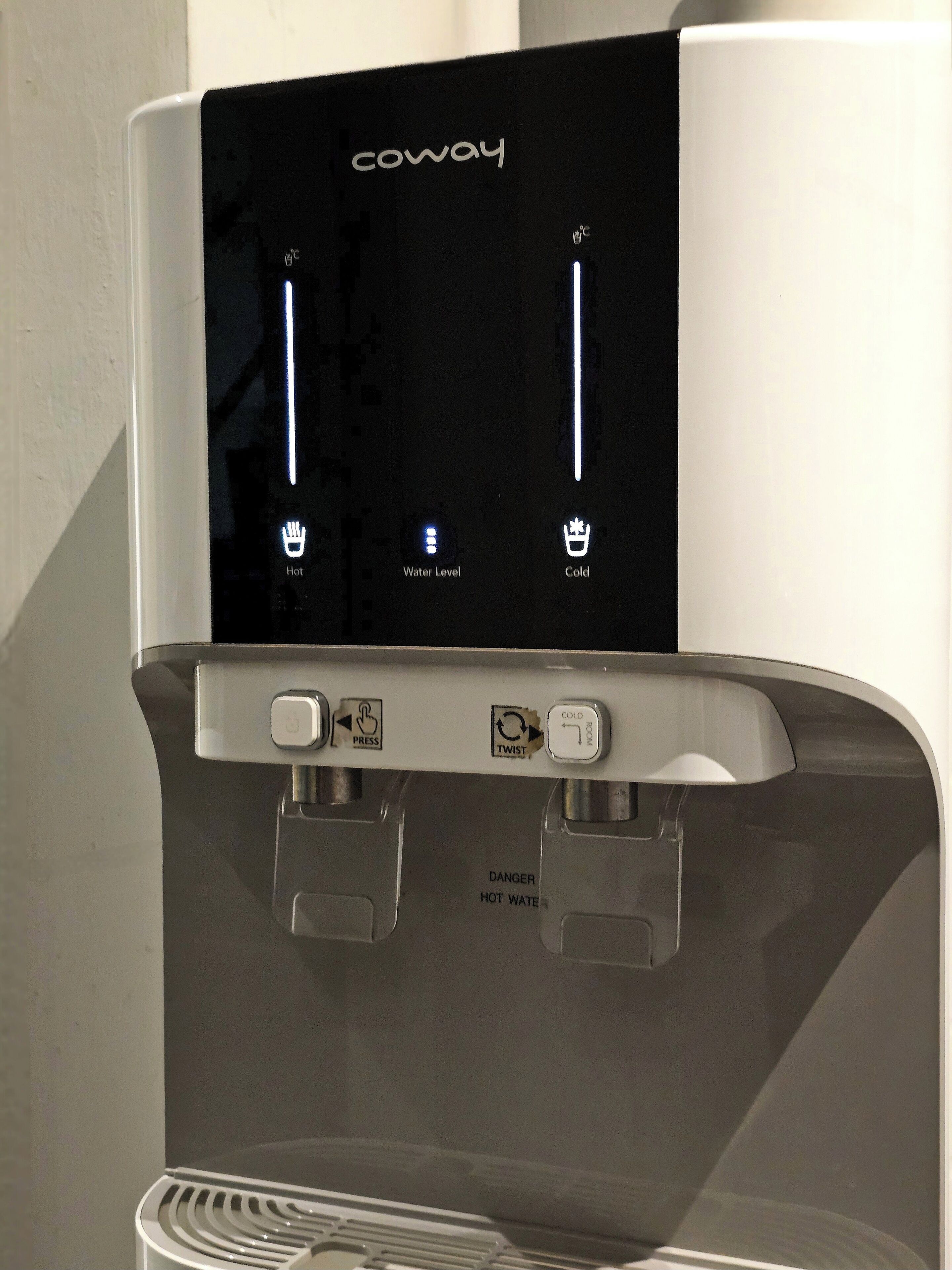 A water dispenser with a digital display, hot and cold water options, and a water level indicator.