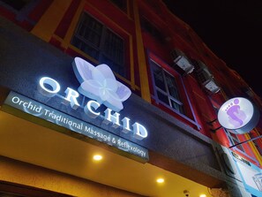 A building with a sign that reads "Orchid Traditional Massage & Reflexology." - Good2Stay Hotel (Malacca City)