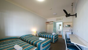 A hotel room with two beds, a desk, and a chair. - Lamington Hotel Motel (Maryborough)