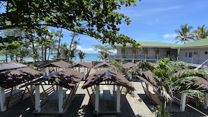 A resort with beachside seating and a view of the ocean.