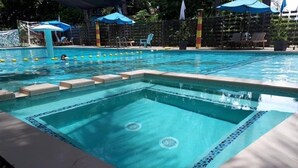 A rectangular swimming pool with a tiled edge and a central drain.