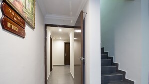 A hotel hallway with a staircase and a door leading to a room. - Valley View Hotel (Lumut)