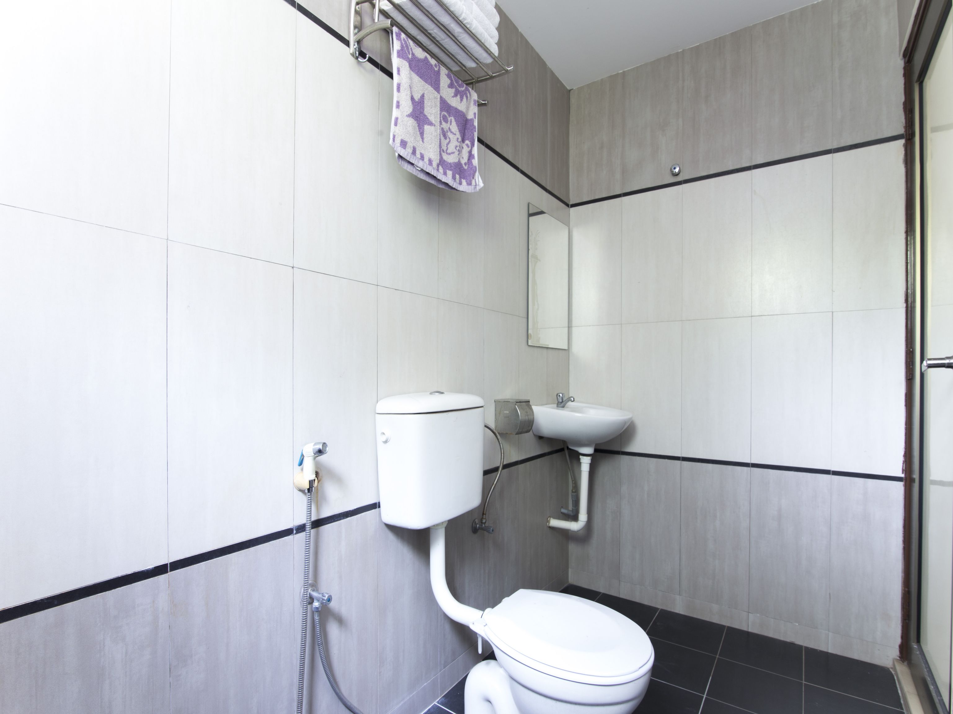 A modern bathroom with a toilet, sink, and shower.