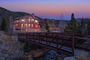 Experience serene mountain living with a comfortable home amidst lush surroundings and a picturesque stream.