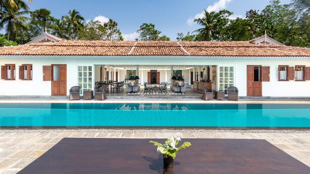 A hotel with a swimming pool, outdoor seating area, and a covered patio. - Nyne Hotels Leela Walauwwa - Induruwa (Induruwa)