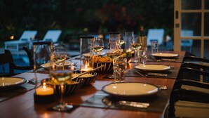 A dining table set for a meal with candles, glasses, and plates. - Nyne Hotels Leela Walauwwa - Induruwa (Induruwa)