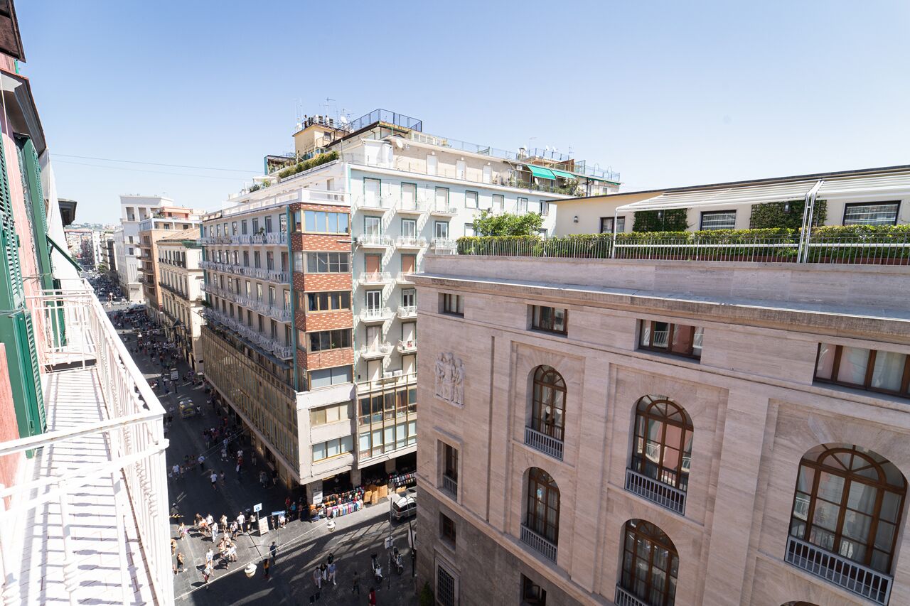 A multi-story building with a central courtyard, balconies, and a mix of architectural styles.
