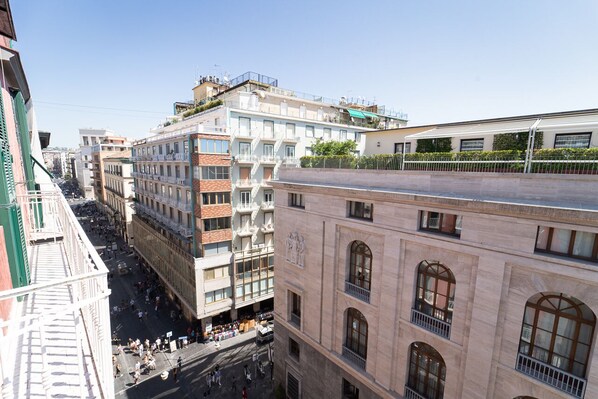 A multi-story building with a central courtyard, balconies, and a mix of architectural styles.