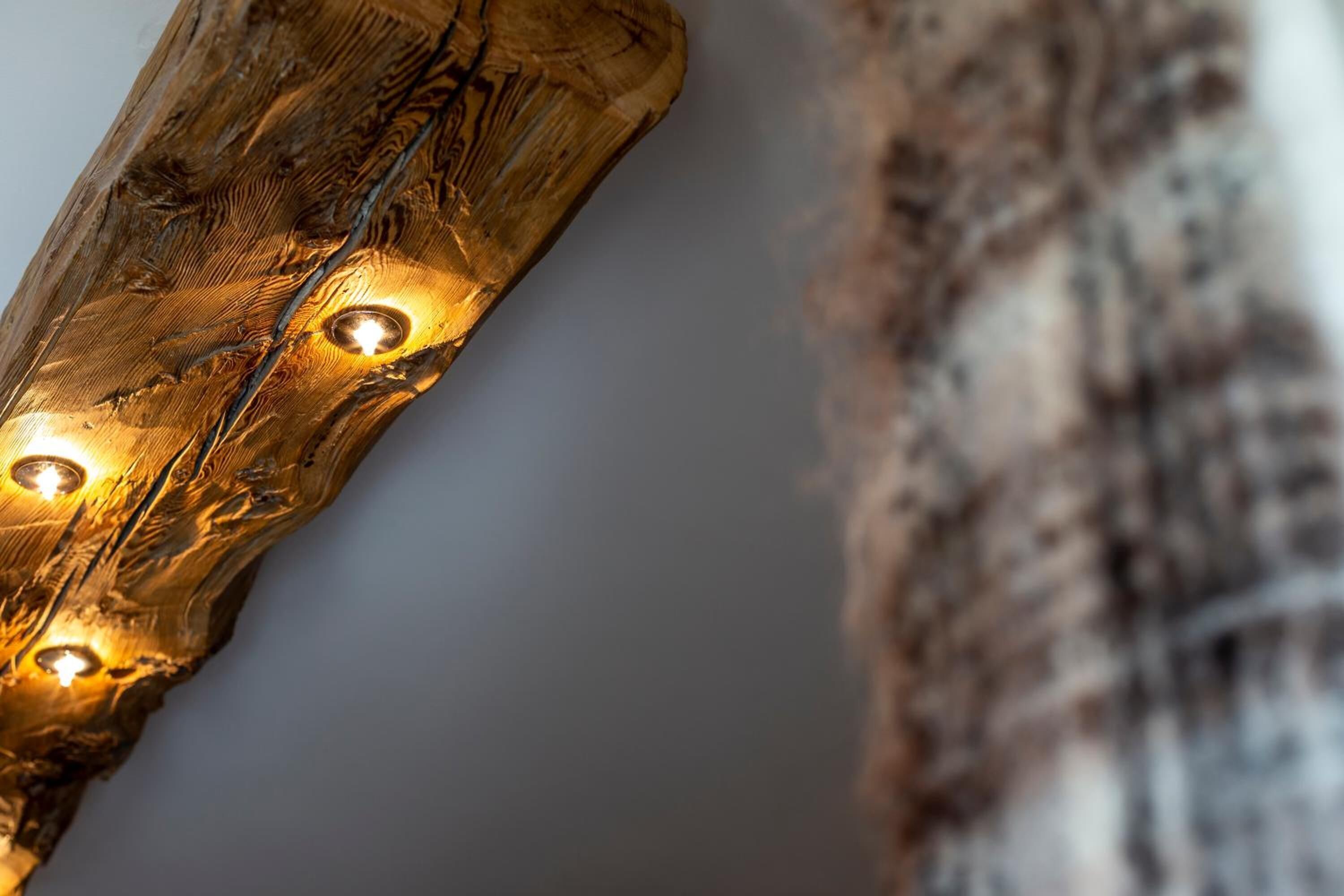 A close-up of a wooden surface with three embedded lights.
