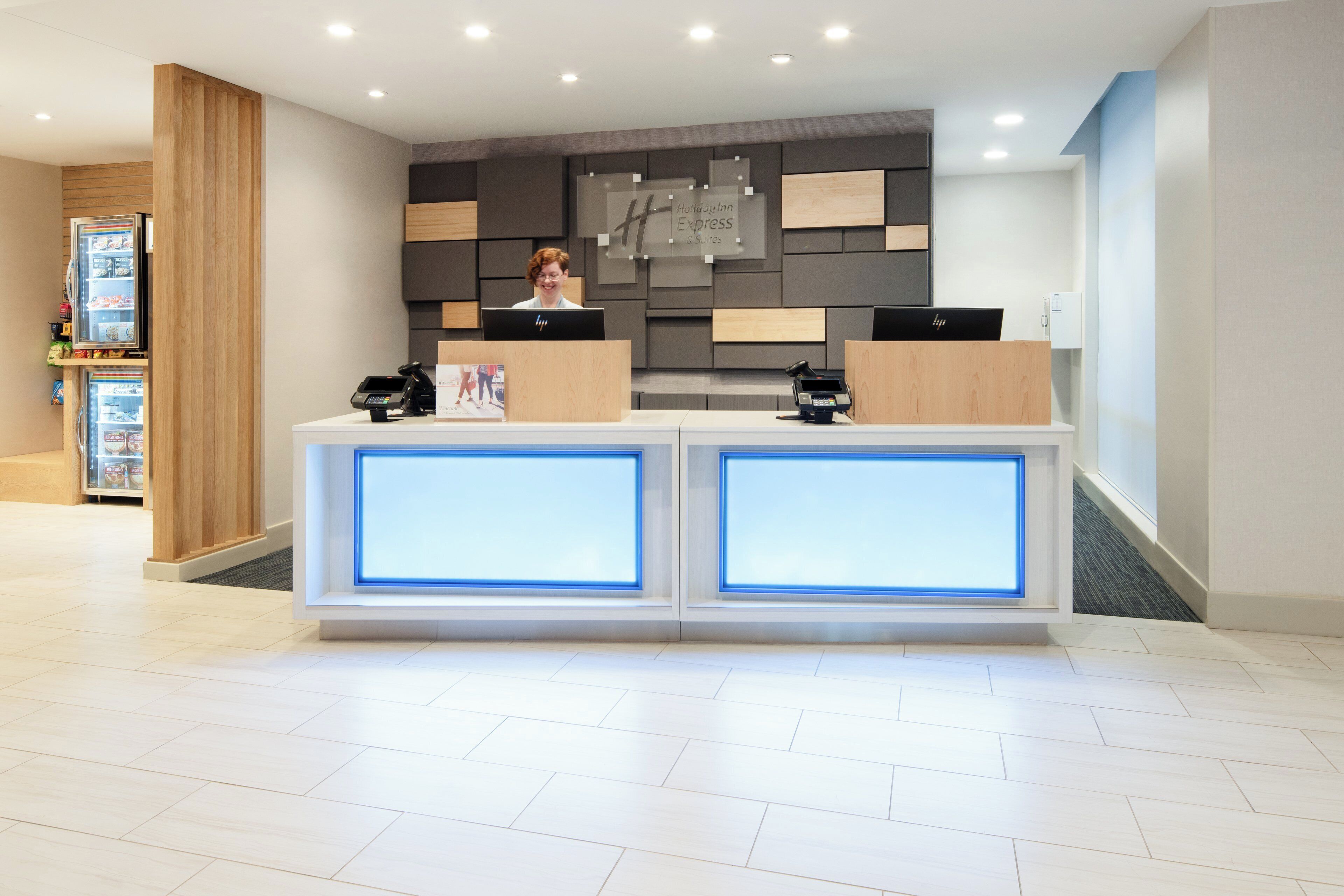 Een hotel receptiebalie met een modern ontwerp, voorzien van een computer en een telefoon.