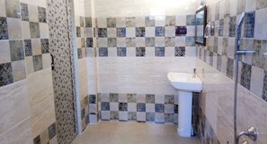 Deluxe-Vierbettzimmer | Badezimmer | Dusche, kostenlose Toilettenartikel, Handtücher