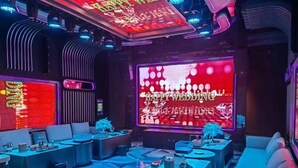 A modern lounge area with seating and a large digital screen displaying a wedding message. - Shenzhen Kaijia Hotel (Shenzhen)