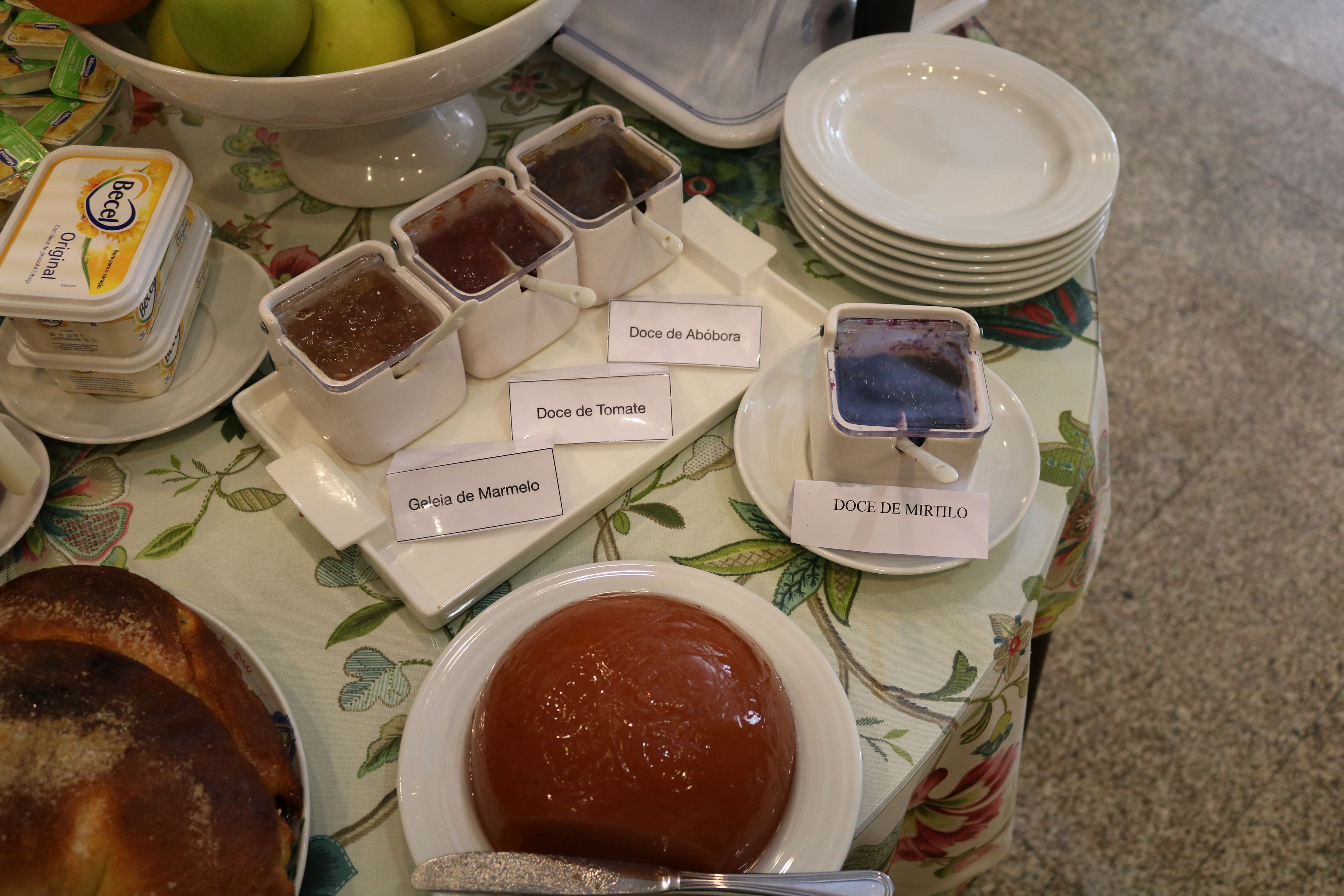 A table with various condiments and a cake.