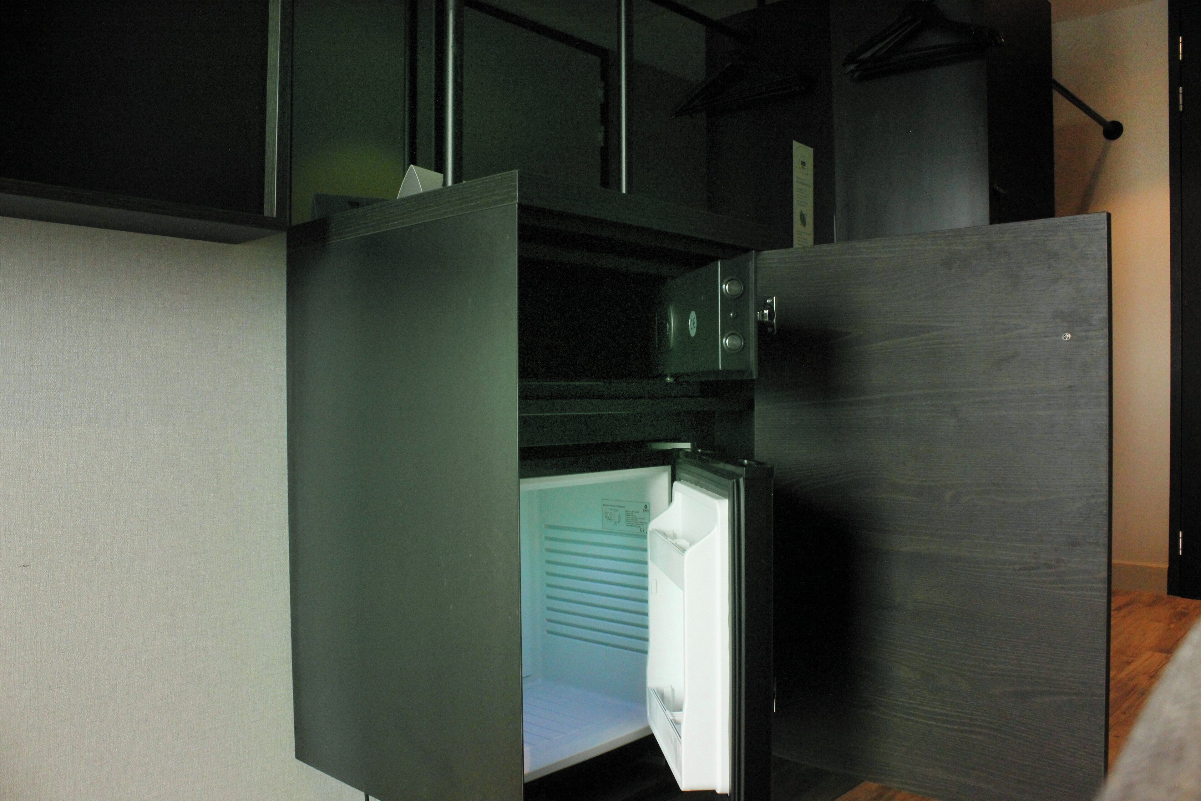 A modern kitchen with a built-in refrigerator and a microwave.