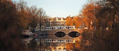 A canal with a bridge and buildings in the background.