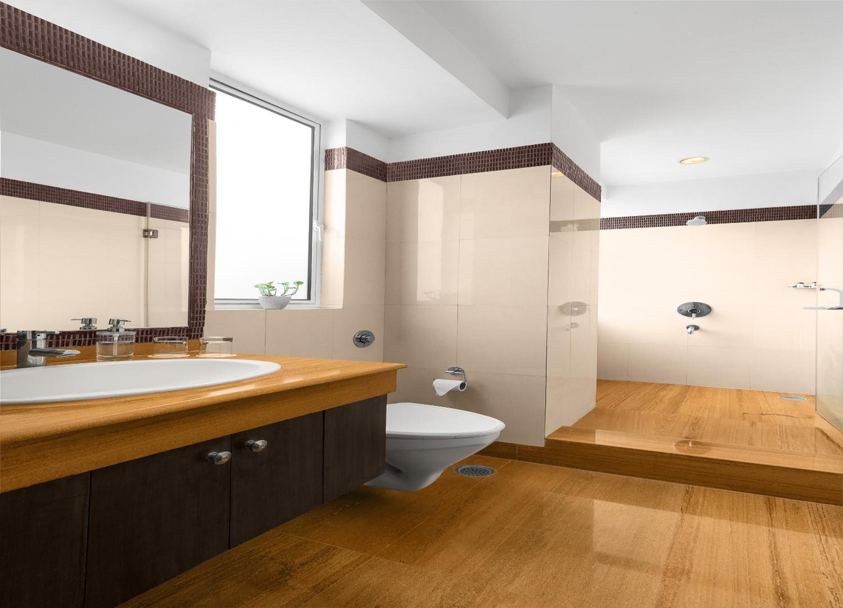 Un baño moderno con dos lavamanos, un inodoro y una zona de ducha.