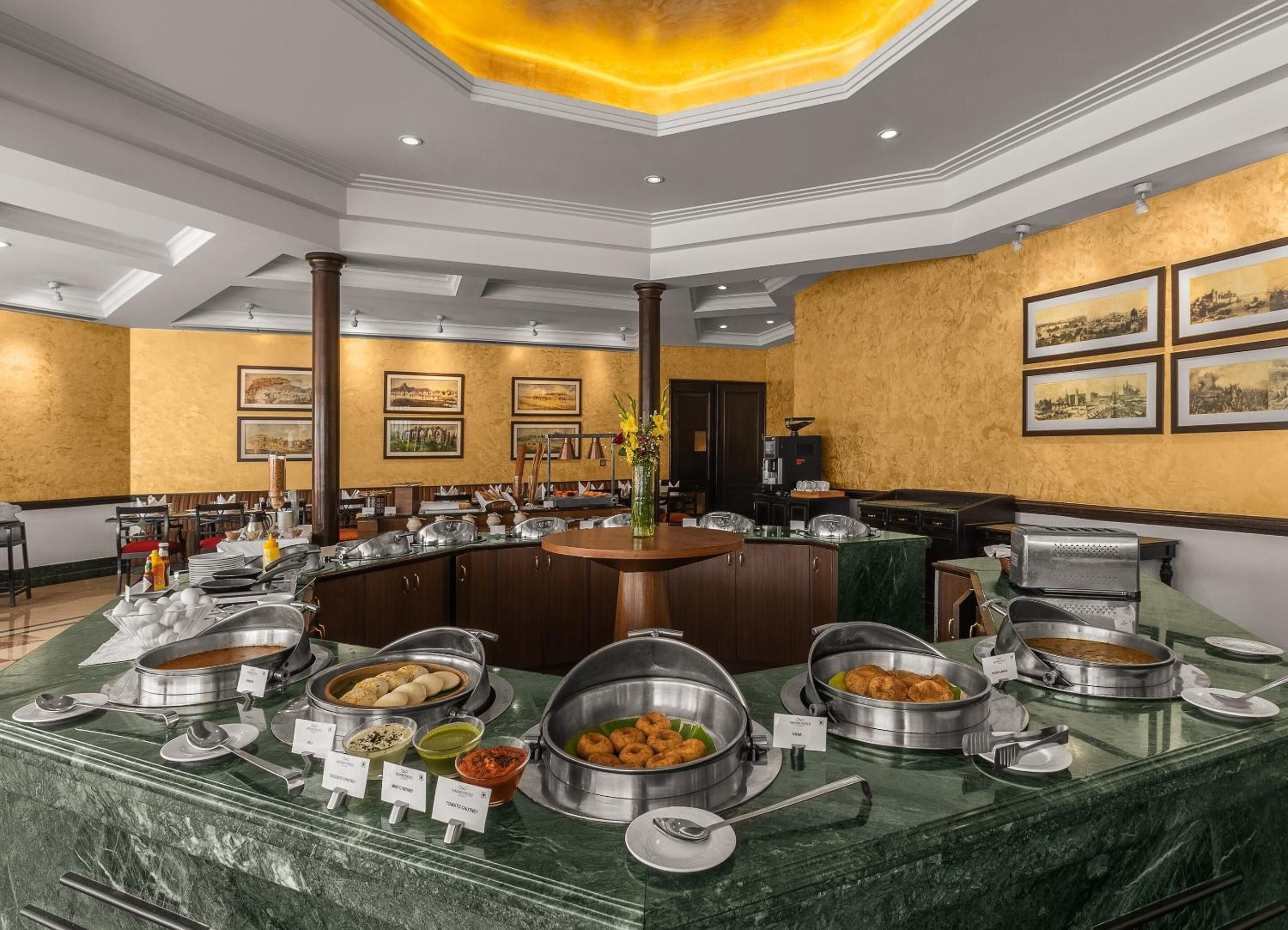 A buffet setup with various food items and a marble counter.