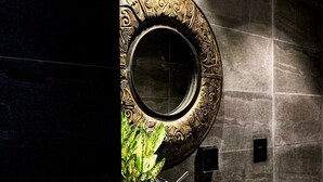 A modern bathroom with a large, ornate mirror, a stone basin, and a wooden countertop. - CHECK inn Phnom Penh BKK 1 (Phnom Penh)