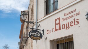 A building with a Coca-Cola sign and a sign for 'Rest. Ca l'Angels'. - Ca L'angels (Prat de Comte)