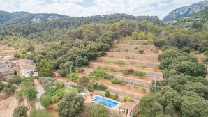 A hillside property with terraced gardens, a swimming pool, and traditional stone buildings. - Aire Can Pieres, Finca 5StarsHome Mallorca (Esporlas)