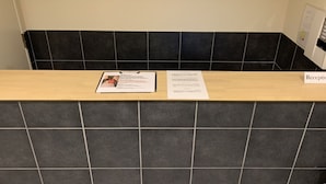 A reception desk with a clipboard and a welcome sign. - F Plus Inn Tofukuji (Kyoto)