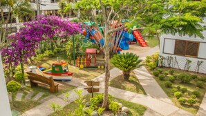 A playground with slides and a boat-shaped play structure. - Village Paraiso Hotel (Florianópolis)