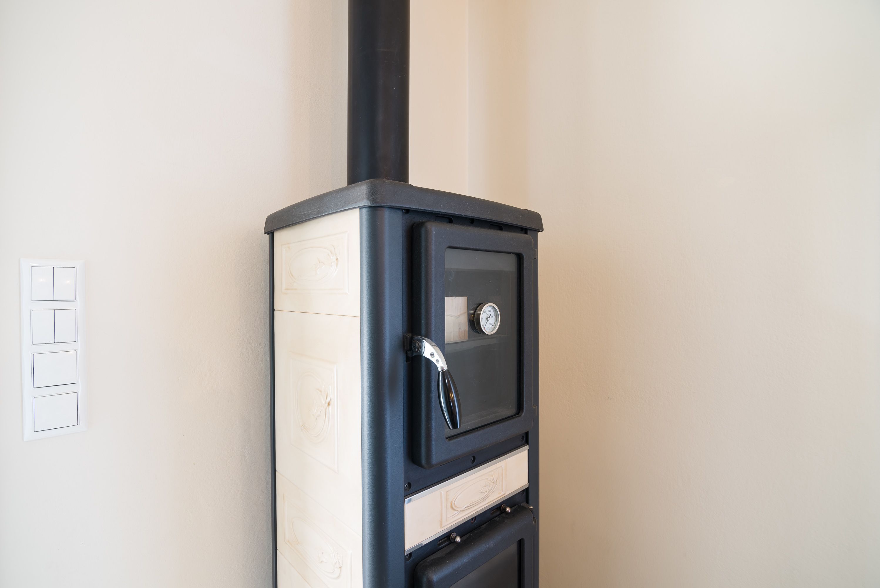 A black and white stove with a digital display and a pressure gauge.