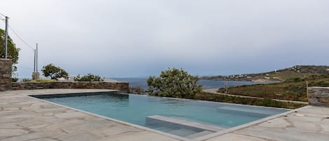 Seasonal outdoor pool, an infinity pool, pool loungers