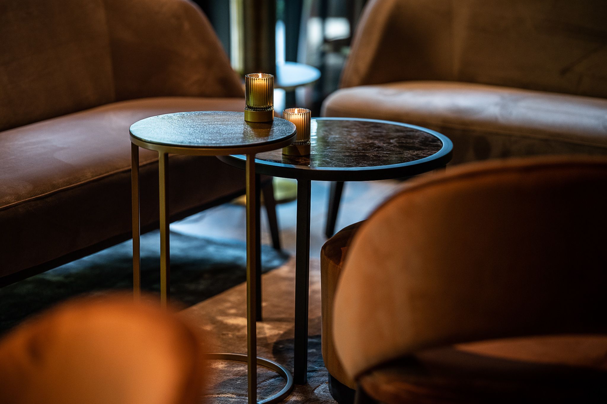 Un coin salon accueillant, avec une table ronde et deux bougies, qui invite à la détente et à la relaxation.
