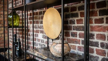 A brick wall with shelves holding decorative items.