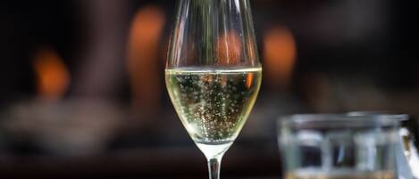 A glass of white wine on a round table with a blurred background.
